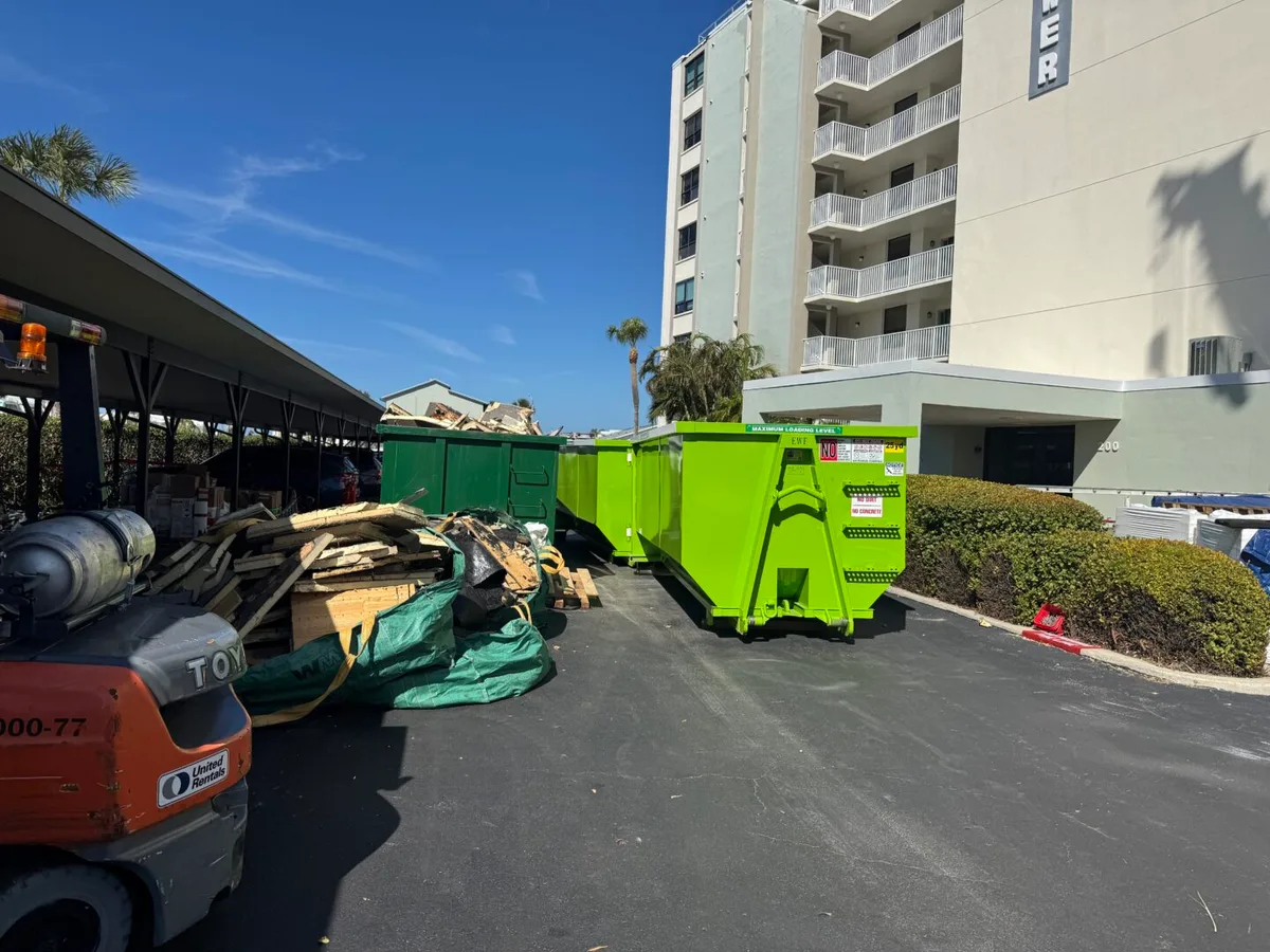 MAXCO dumpster filled with shingle roofing tear-off debris