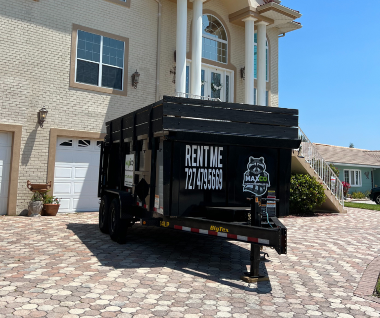a driveway safe dump trailer resting on a paver driveway in a gulf harbors neighborhood inside new port richey